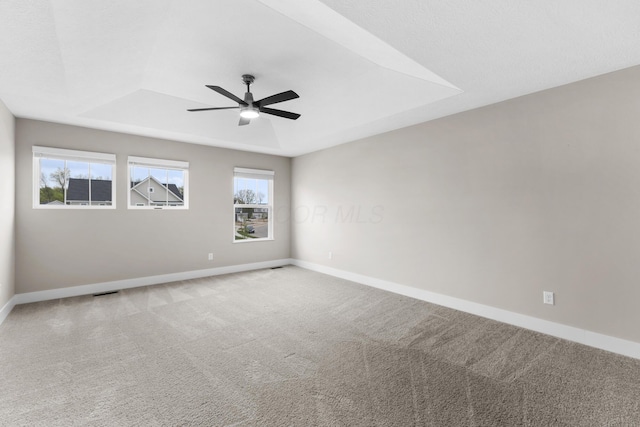 1206 Clover St, Sunbury, OH 43074 - empty room with baseboards, a ceiling fan, a tray ceiling, and carpet flooring