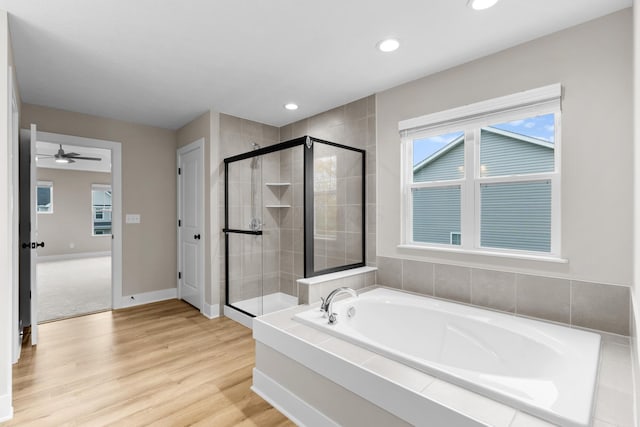 1206 Clover St, Sunbury, OH 43074 - full bathroom featuring a stall shower, recessed lighting, a garden tub, and wood finished floors