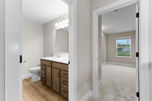 1206 Clover St, Sunbury, OH 43074 - bathroom featuring toilet, baseboards, and vanity