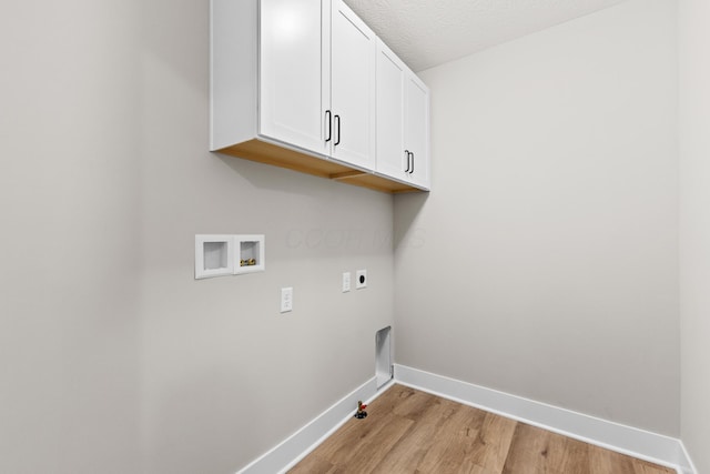 1206 Clover St, Sunbury, OH 43074 - laundry room featuring hookup for a gas dryer, baseboards, light wood-type flooring, cabinet space, and washer hookup