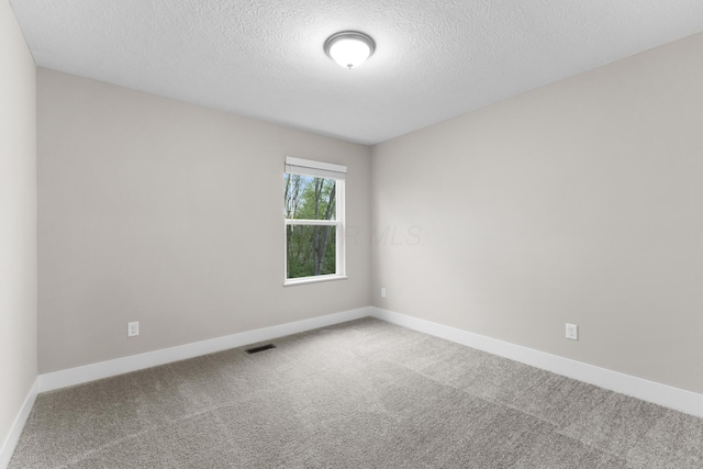 1206 Clover St, Sunbury, OH 43074 - spare room featuring carpet flooring, a textured ceiling, baseboards, and visible vents