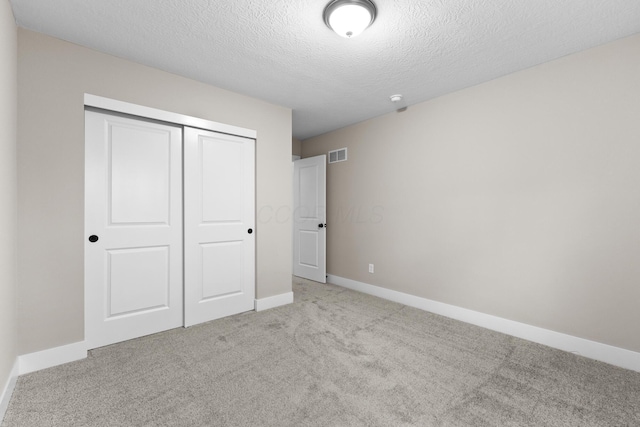 1206 Clover St, Sunbury, OH 43074 - unfurnished bedroom featuring carpet floors, a textured ceiling, baseboards, visible vents, and a closet