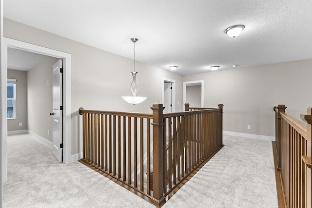 1206 Clover St, Sunbury, OH 43074 - hallway with baseboards, light carpet, and an upstairs landing