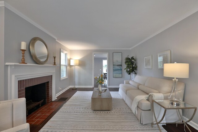 living area featuring ornamental molding, baseboards, a fireplace, and wood finished floors