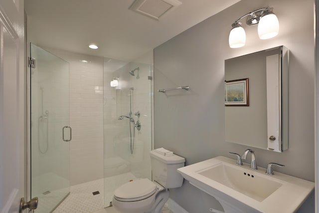 full bath featuring a sink, a shower stall, toilet, and recessed lighting