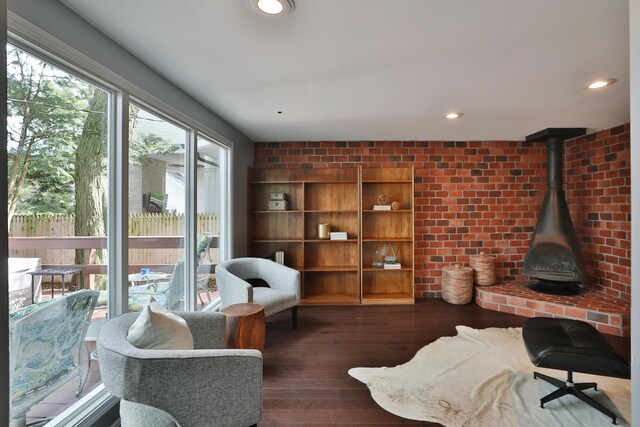 living area featuring hardwood / wood-style flooring, a wood stove, and recessed lighting