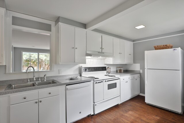 kitchen with white appliances, under cabinet range hood, a sink, white cabinets, and beamed ceiling