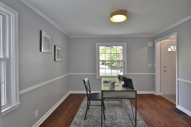 office space featuring wood finished floors, crown molding, and baseboards