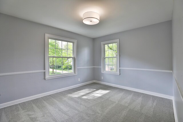 spare room featuring baseboards and carpet