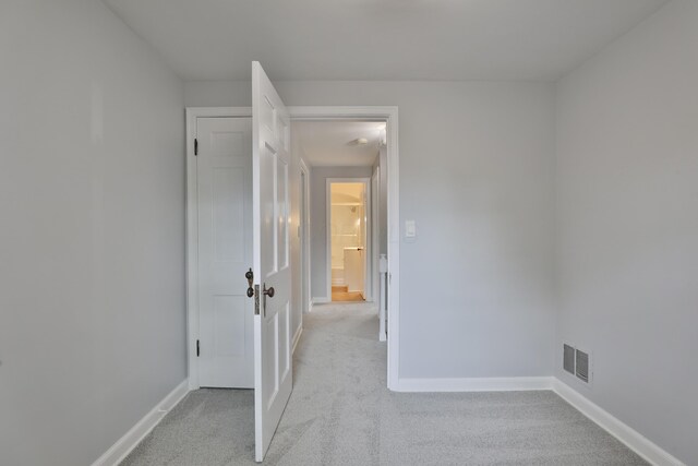 unfurnished bedroom featuring carpet flooring and baseboards
