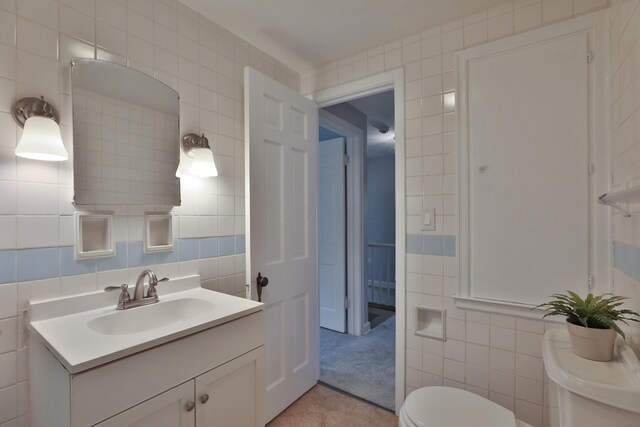 bathroom featuring tile walls, toilet, tile patterned floors, and vanity