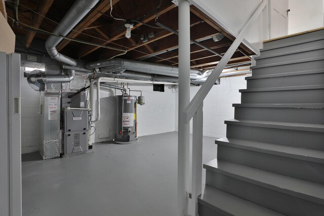 unfinished basement with gas water heater, stairway, and heating unit