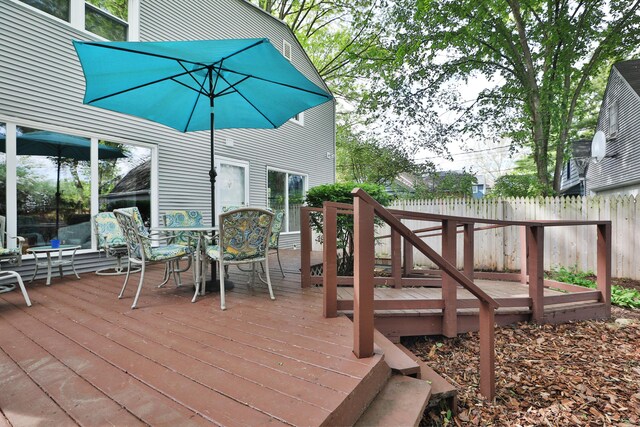 wooden terrace featuring fence and outdoor dining area