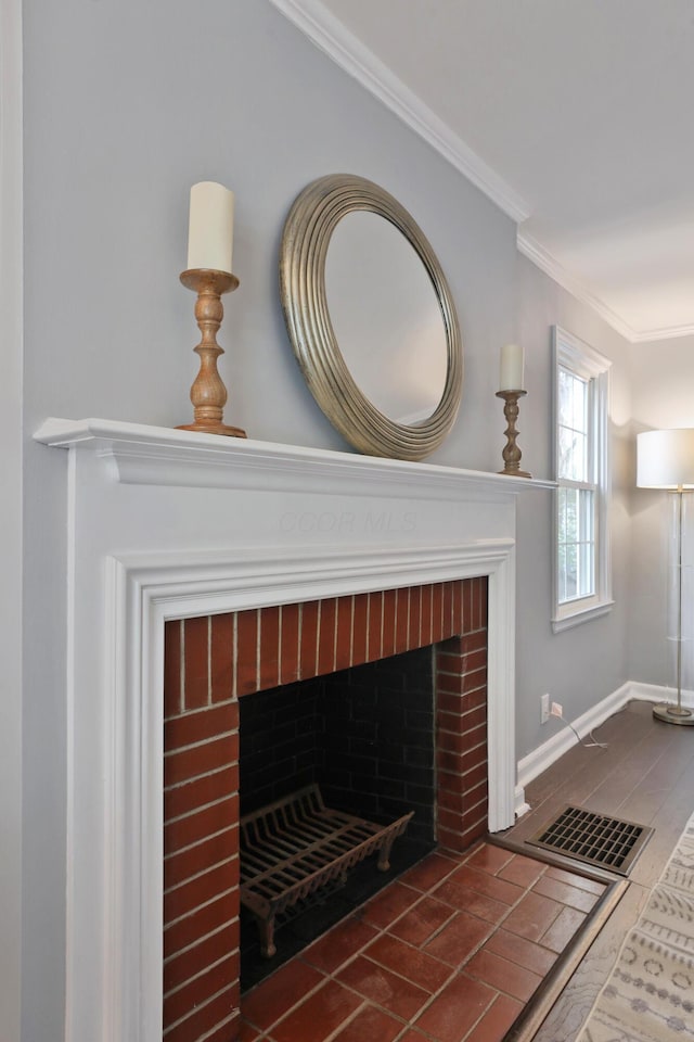 detailed view of crown molding, a fireplace, and baseboards