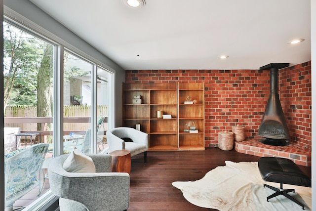 living area featuring hardwood / wood-style flooring, a wood stove, and recessed lighting