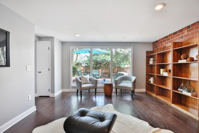 sitting room with dark wood-style floors, baseboards, and recessed lighting