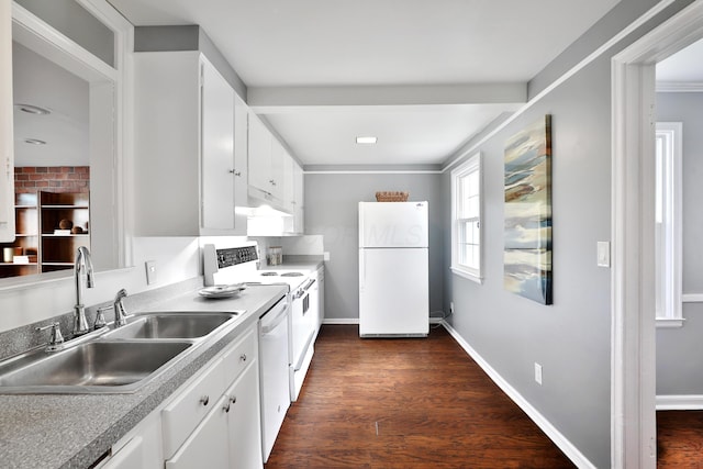 kitchen featuring white appliances, a sink, under cabinet range hood, white cabinets, and dark wood-type flooring