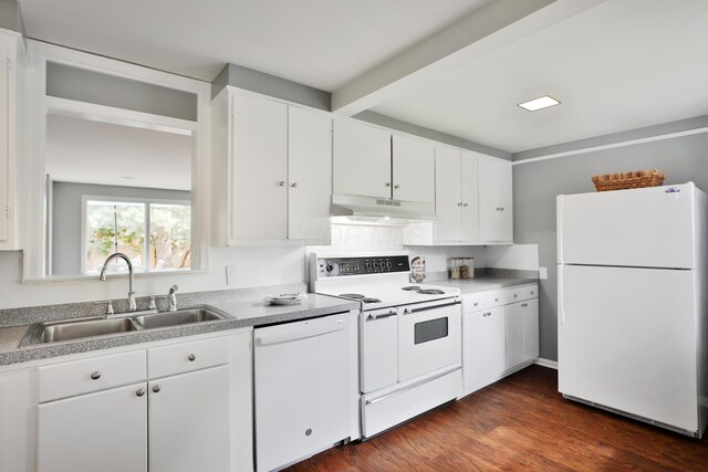 kitchen featuring white appliances, under cabinet range hood, a sink, white cabinets, and beam ceiling