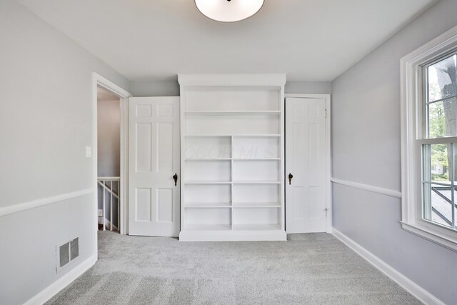 unfurnished bedroom featuring carpet flooring and baseboards