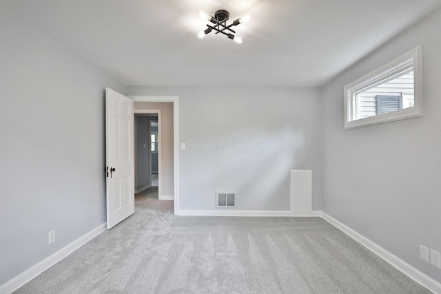 carpeted empty room with baseboards