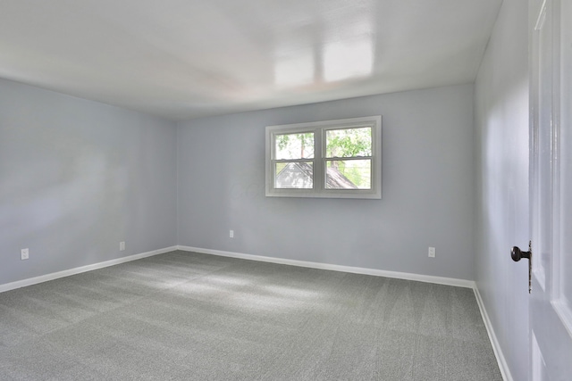 carpeted empty room with baseboards