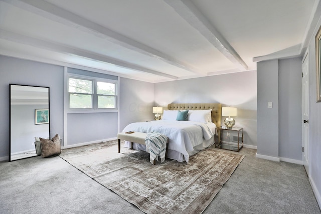 bedroom with carpet floors, beam ceiling, and baseboards
