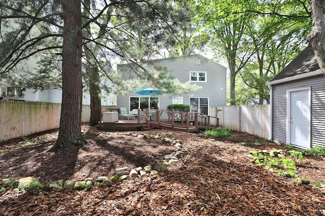 back of property with fence and a deck