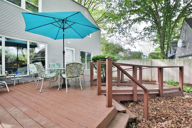 deck featuring fence and outdoor dining area