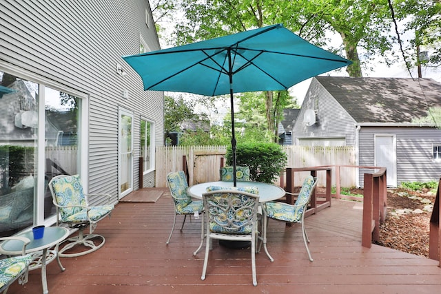 deck with fence and outdoor dining area