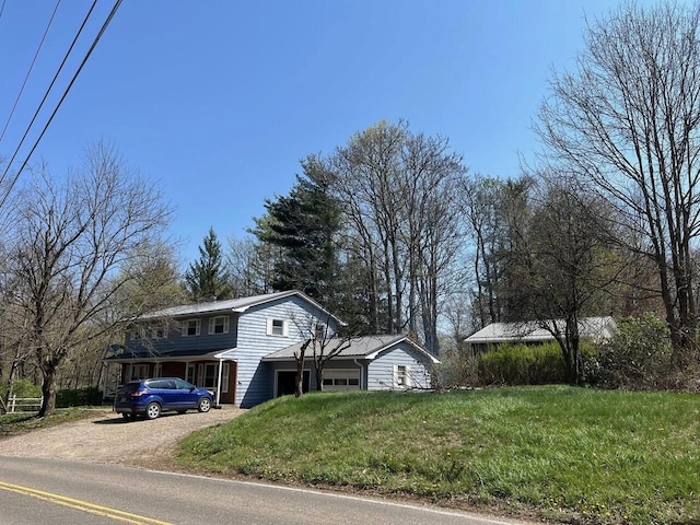 25 N Liberty St, New Concord, OH 43762 - view of home's exterior featuring driveway, a yard, and an attached garage