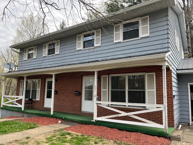 25 N Liberty St, New Concord, OH 43762 - view of front of house with a porch and brick siding