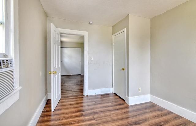 interior space with baseboards, visible vents, and wood finished floors