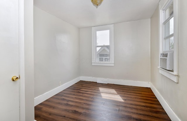 spare room with visible vents, dark wood finished floors, and baseboards