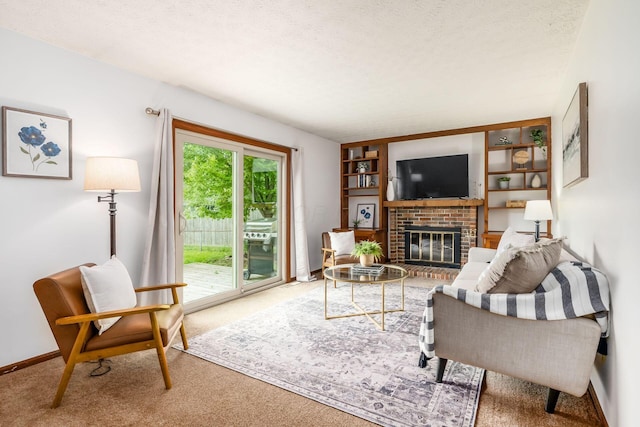 carpeted living room with a brick fireplace, a textured ceiling, and baseboards