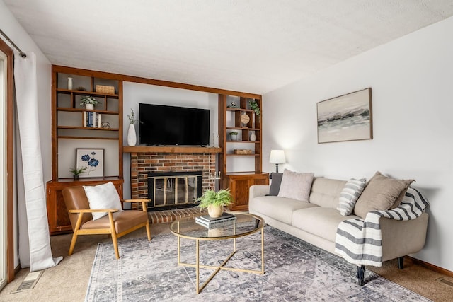 living room with a fireplace, carpet, and built in shelves