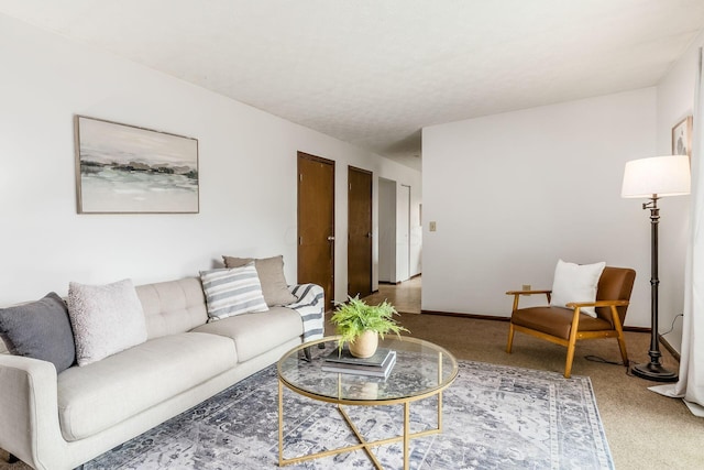 carpeted living area featuring baseboards