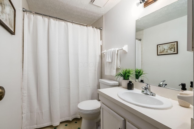 full bathroom featuring a textured ceiling, toilet, and vanity