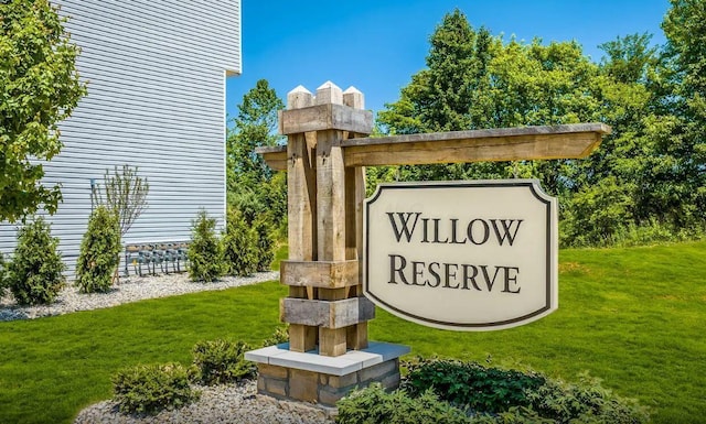 community / neighborhood sign with a lawn