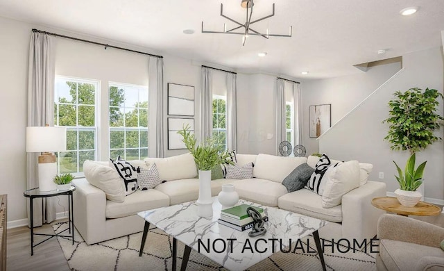 living room with baseboards, recessed lighting, a wealth of natural light, and light wood-style floors