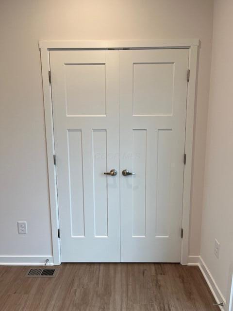 details with baseboards, visible vents, and wood finished floors
