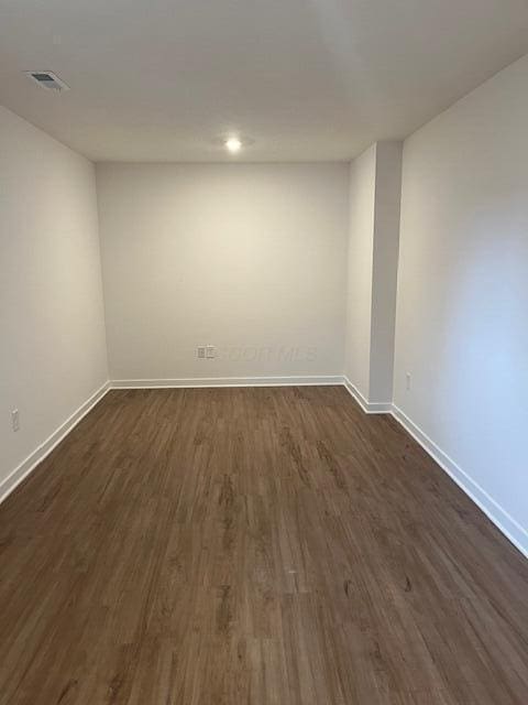 interior space with dark wood-style floors, recessed lighting, visible vents, and baseboards