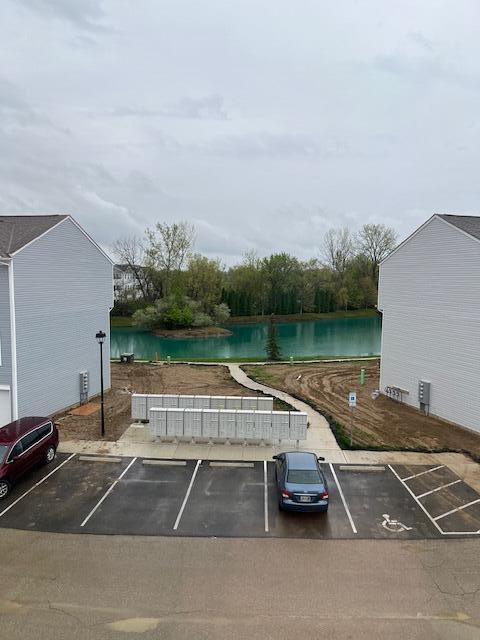 uncovered parking lot with a water view