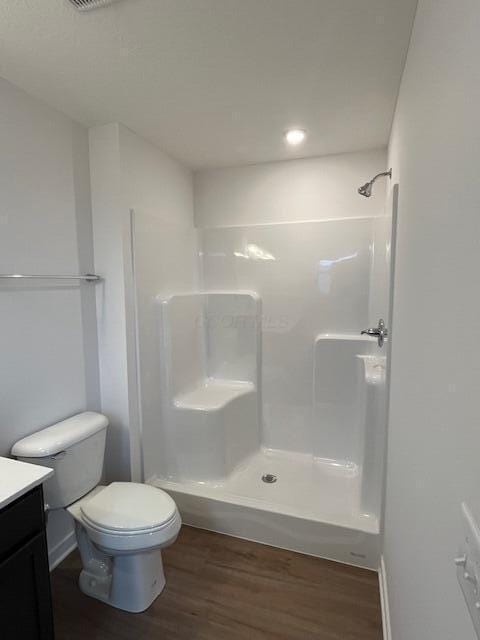 full bath with recessed lighting, vanity, toilet, walk in shower, and wood finished floors