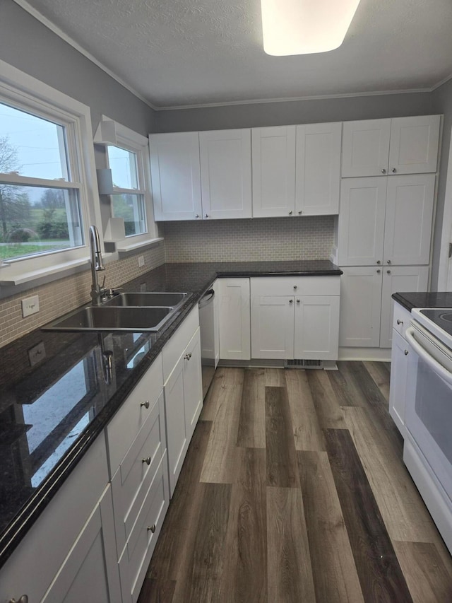 kitchen with white electric range oven, white cabinetry, a sink, dishwasher, and dark wood finished floors