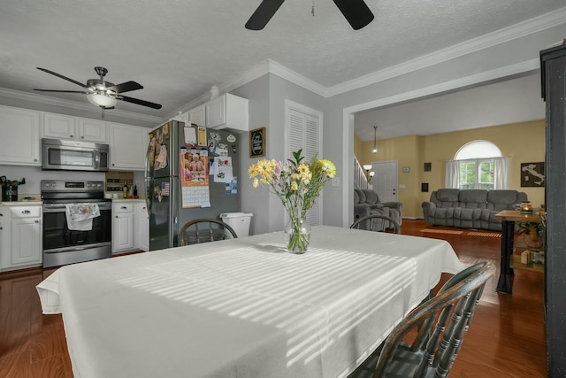 dining space with crown molding, ceiling fan, and dark wood finished floors
