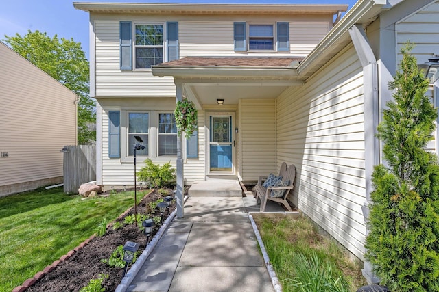 property entrance with a lawn