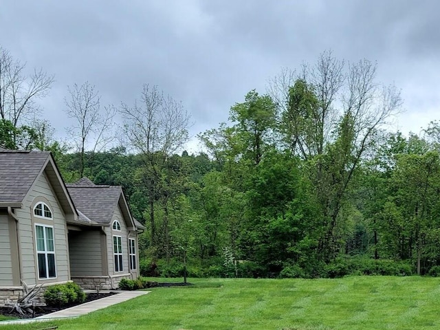 view of yard with a view of trees