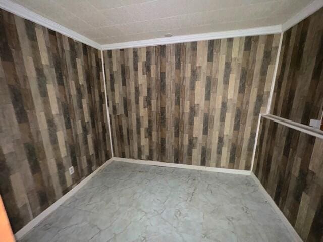 empty room featuring wood walls
