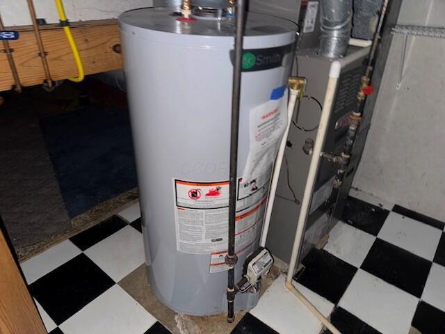 utility room featuring water heater