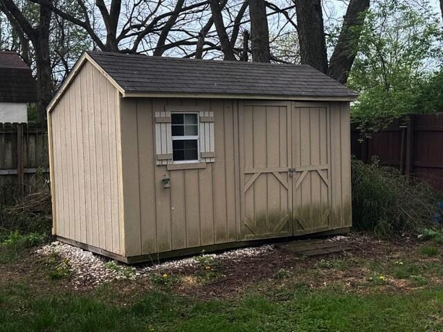 view of shed with fence
